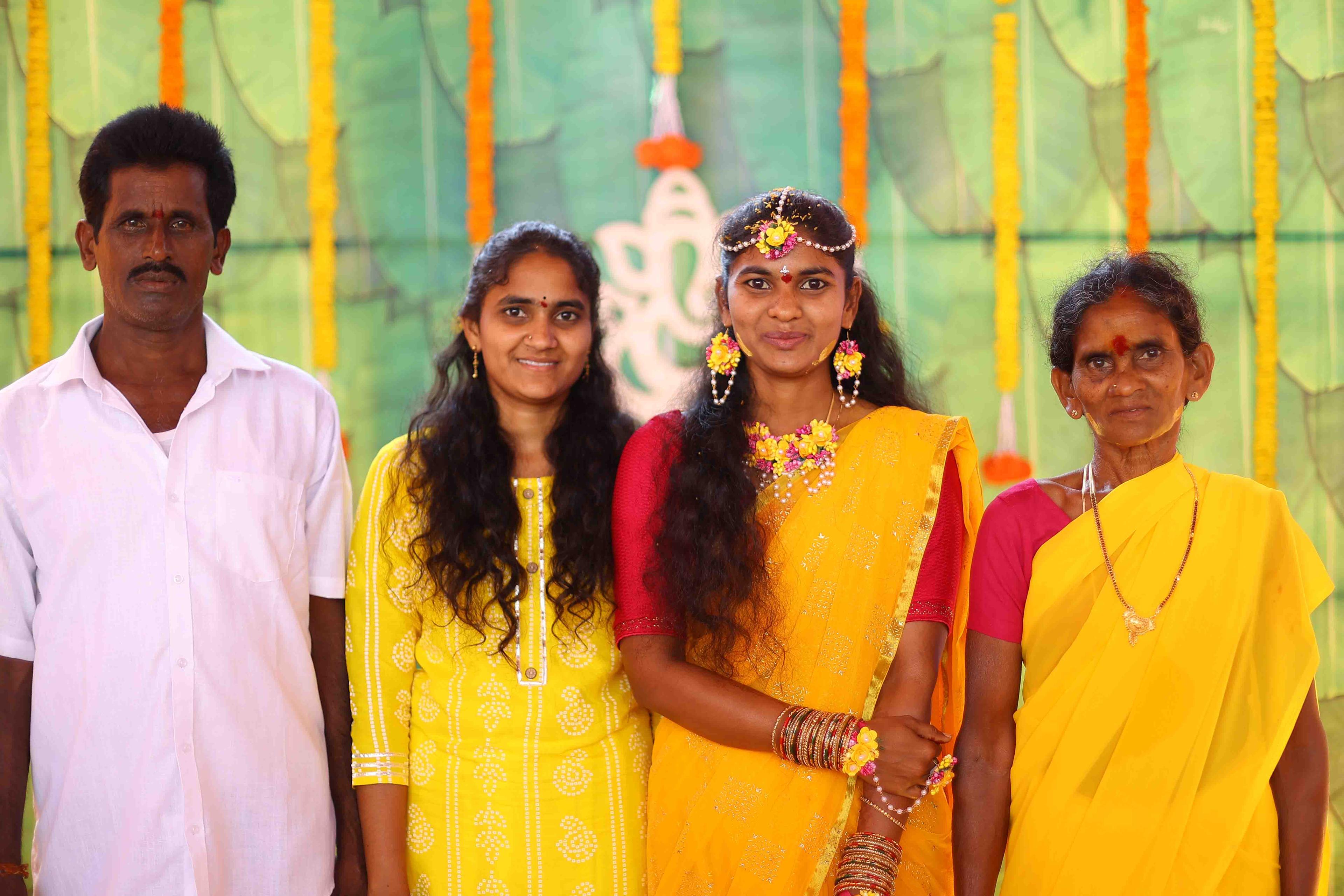 Eswari posing beautifully with her family during the haldi event