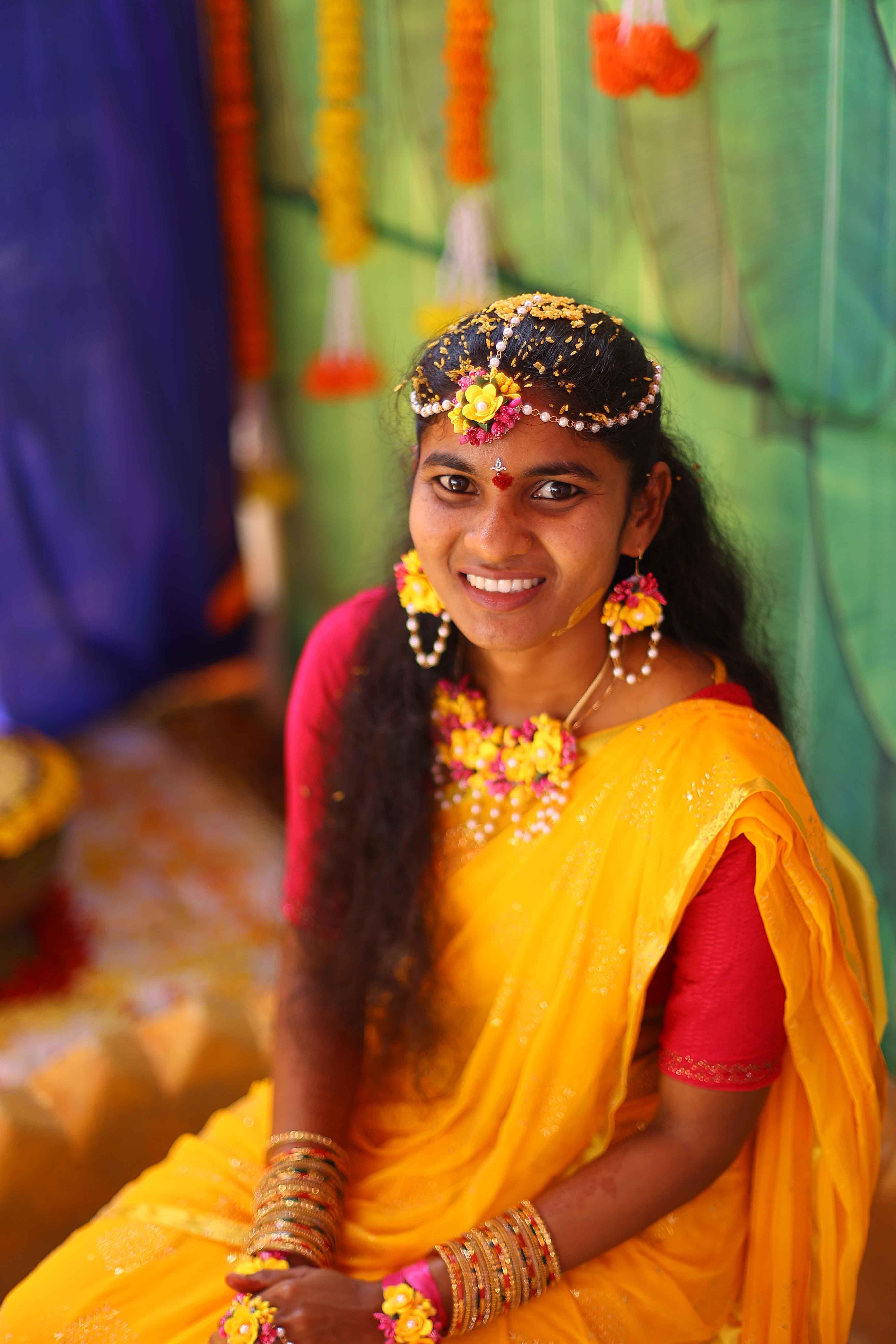 Beautiful portrait of Eswari smiling gracefully during the haldi ceremony