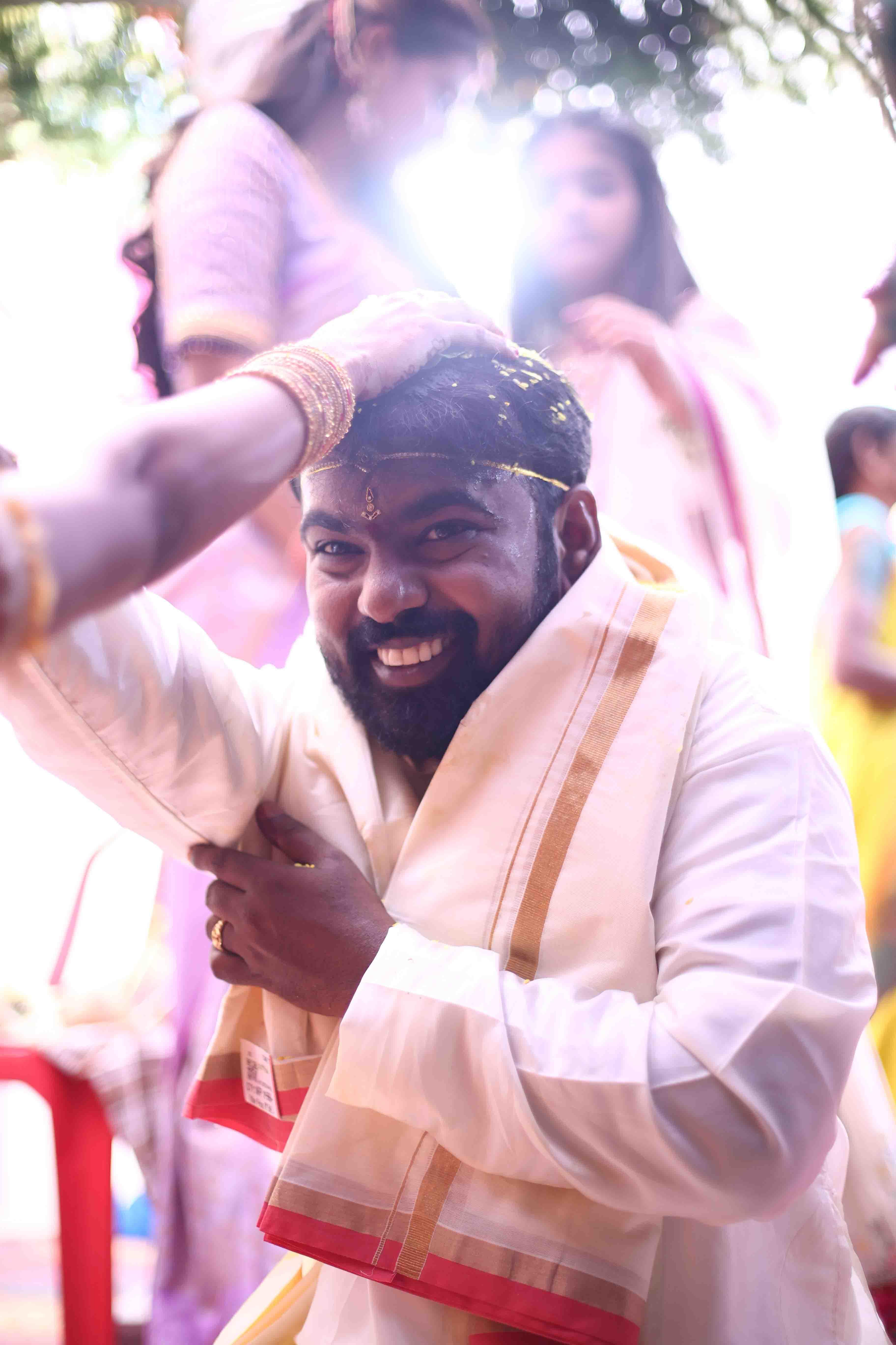 Anil joyfully participating in the ceremony with a bright smile