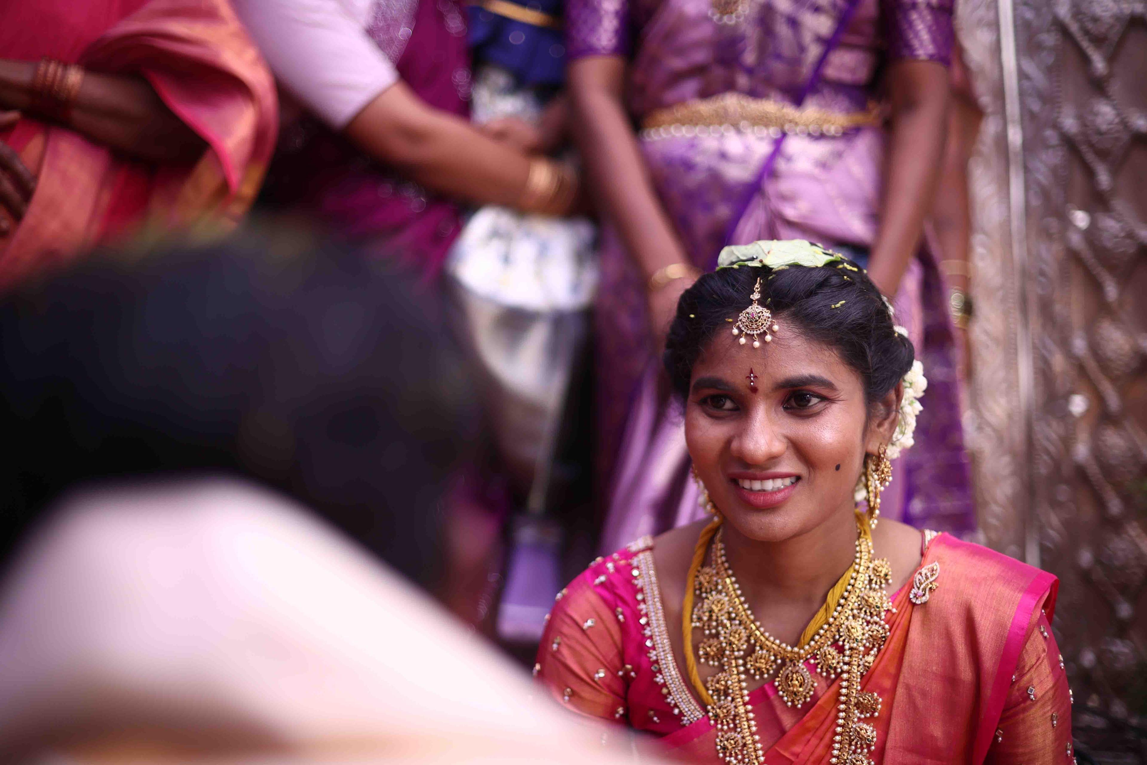 A candid joyful portrait of Eswari during the wedding moments