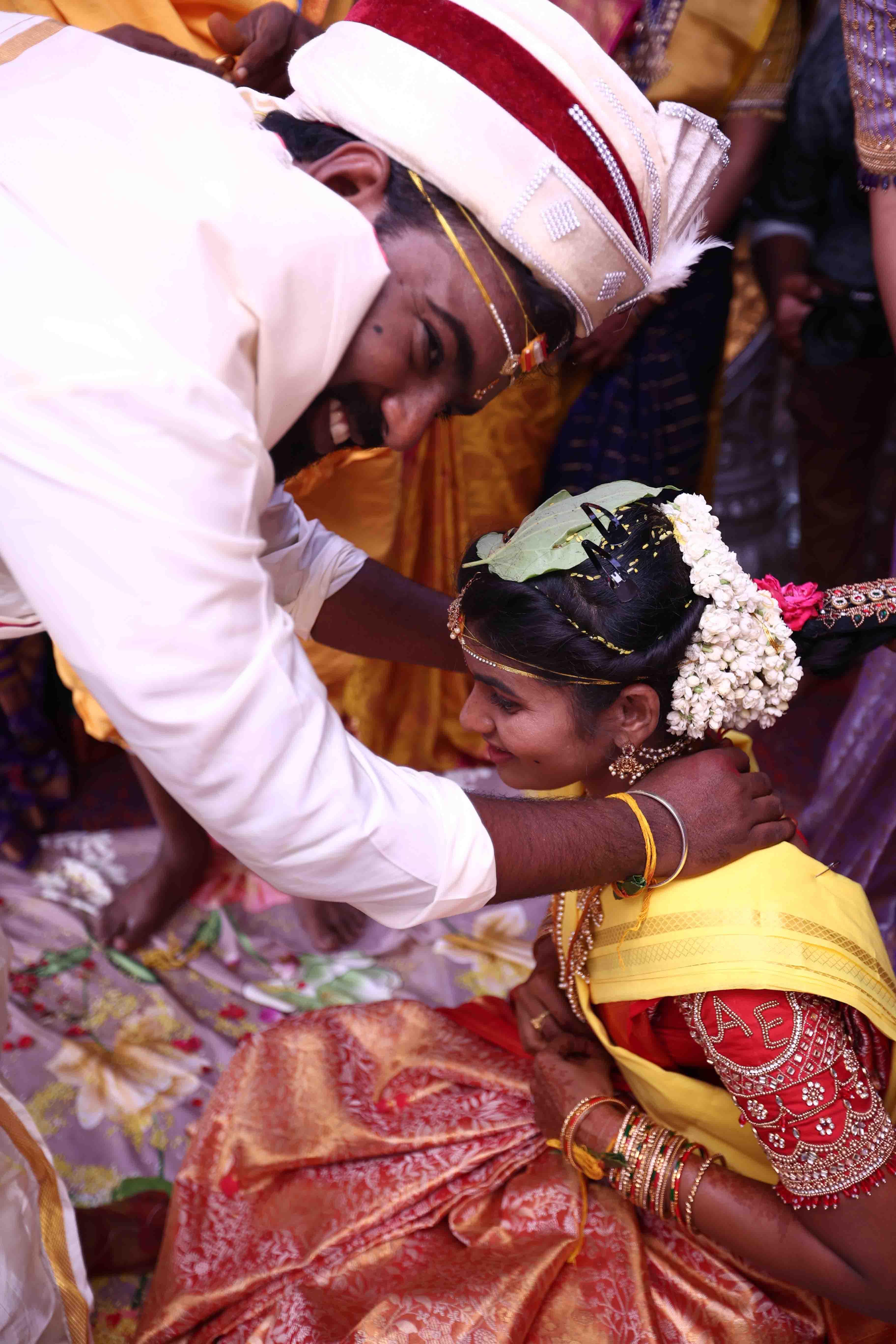 A tender wedding moment as the couple stands close together