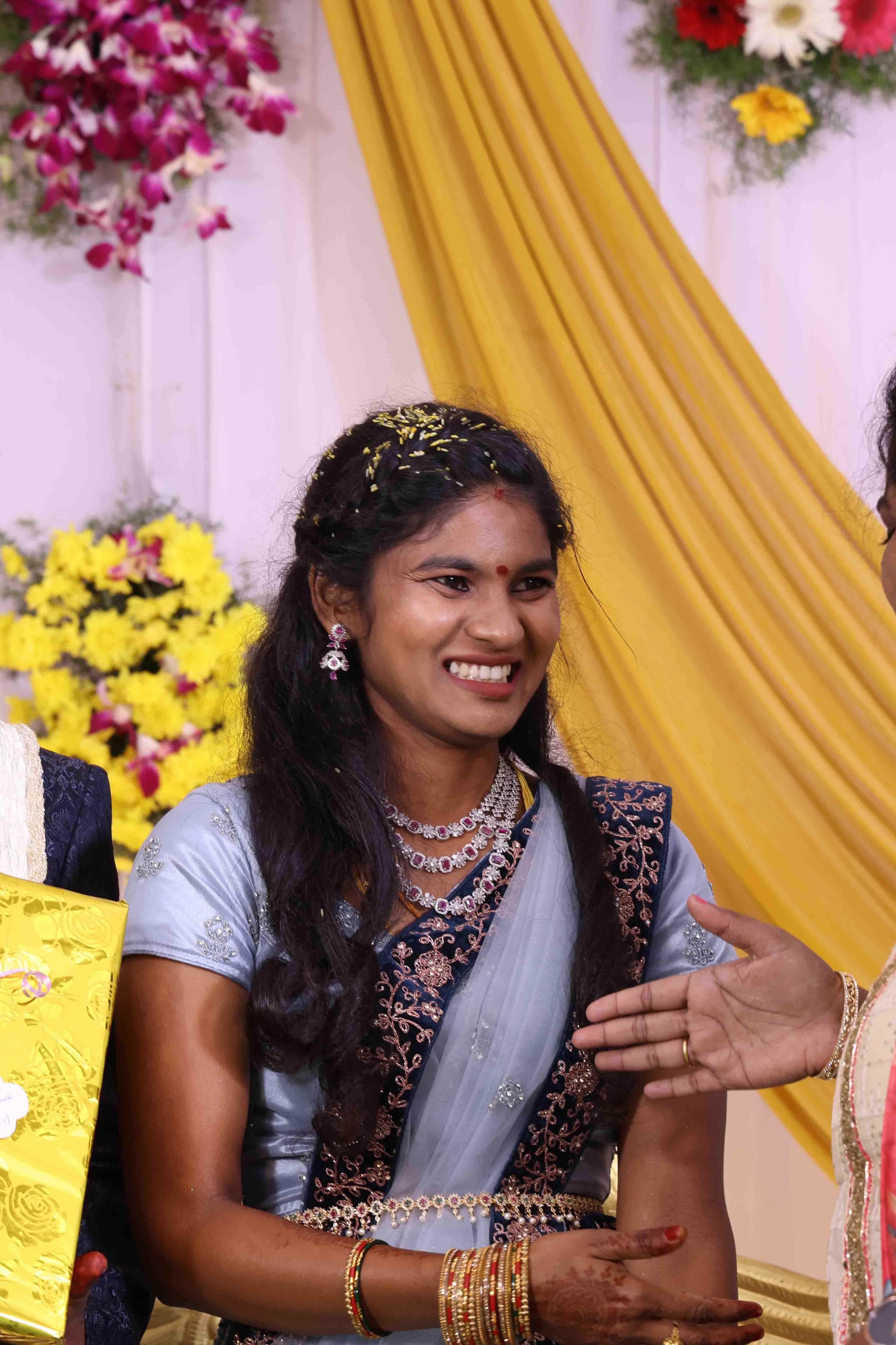 Eswari smiling beautifully during the reception evening celebration