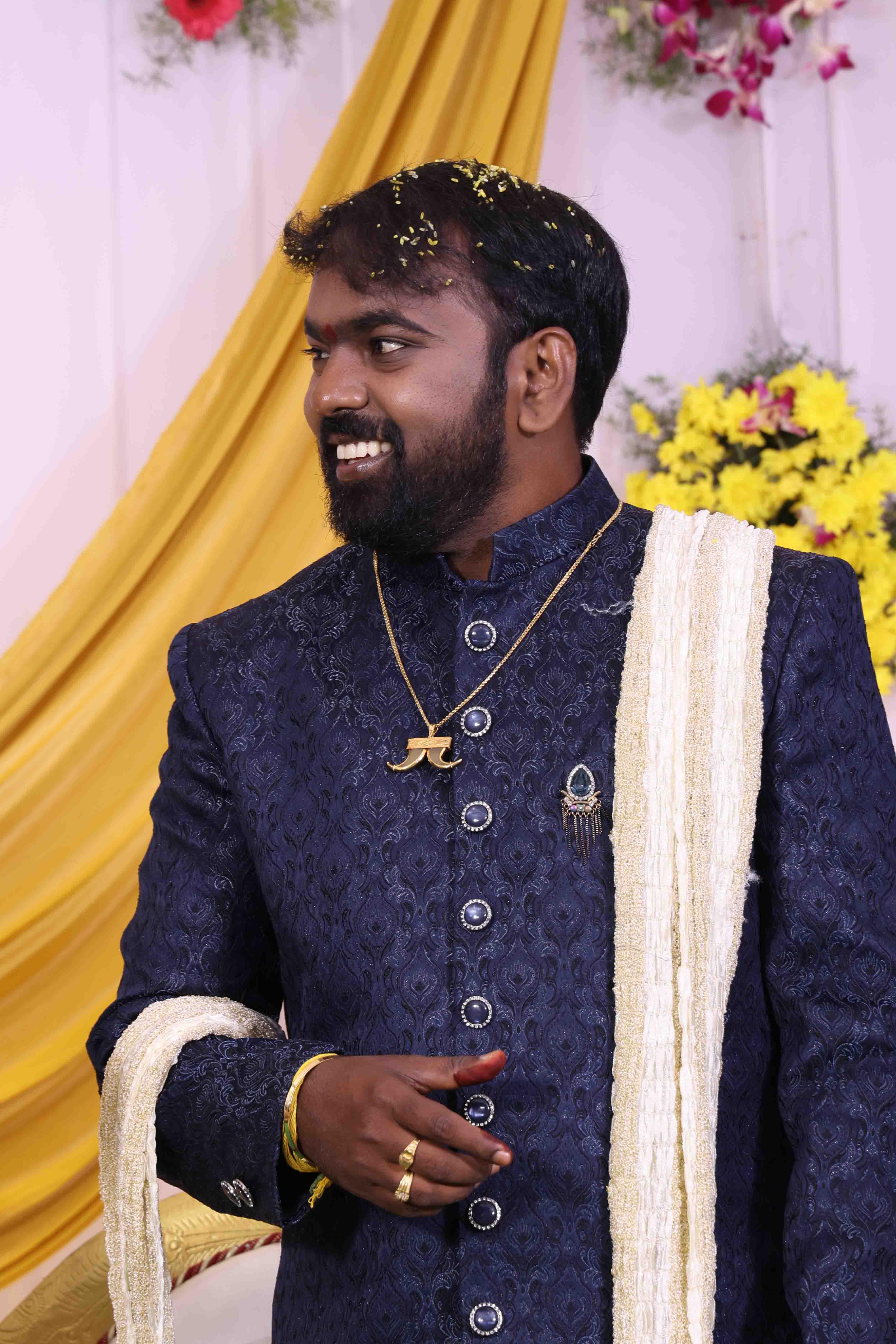 Anil smiling as the reception celebrations begin on stage